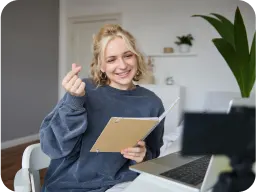 girl with heart gesture and book image